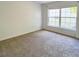 Bedroom with neutral walls and carpet featuring windows for natural light at 1017 Siena Park E Blvd, Celebration, FL 34747