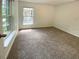 Bedroom with neutral walls and carpet, featuring a window for natural lighting at 1017 Siena Park E Blvd, Celebration, FL 34747