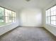 Bright bedroom filled with natural light, complemented by neutral carpet, baseboards, and trim at 1017 Siena Park E Blvd, Celebration, FL 34747