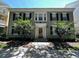 Charming two-story townhouse with black shutters, complemented by beautiful landscaping and a welcoming front entrance at 1017 Siena Park E Blvd, Celebration, FL 34747