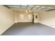 Spacious garage with painted floor, white walls and windows for natural light at 1017 Siena Park E Blvd, Celebration, FL 34747