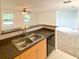 Kitchen area features a double sink, dishwasher, light-colored cabinets and neutral countertops at 1017 Siena Park E Blvd, Celebration, FL 34747