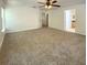 Spacious main bedroom with neutral carpet, ceiling fan, and access to a bathroom and walk-in closet at 1017 Siena Park E Blvd, Celebration, FL 34747