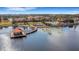 Scenic aerial view of community pool, clubhouse, and lake featuring a wooden pier with a covered seating area at 1036 Salamanca Pl, Davenport, FL 33837