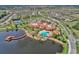 Amazing aerial shot of the community's lake, resort-style pool, clubhouse, and surrounding neighborhood at 1036 Salamanca Pl, Davenport, FL 33837