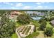 Aerial view showcasing the community clubhouse, garden, lake, and tennis courts at 1036 Salamanca Pl, Davenport, FL 33837