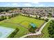 Aerial view of the community dog park and playground area with green space and seating at 1036 Salamanca Pl, Davenport, FL 33837