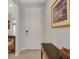 Bright entryway with tile floors, a white door, and a console table decorated with a seasonal pumpkin at 1036 Salamanca Pl, Davenport, FL 33837