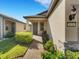 Inviting front entrance with a brick pathway, lush landscaping, and a cozy seating area on the porch at 1036 Salamanca Pl, Davenport, FL 33837