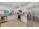 Bright kitchen features stainless steel appliances, white cabinetry, granite countertops, tile backsplash, and tile floors at 1036 Salamanca Pl, Davenport, FL 33837