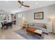 Comfortable living room with modern decor, featuring neutral-toned sofa, wood coffee table, ceiling fan, and tile flooring at 1036 Salamanca Pl, Davenport, FL 33837