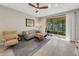 Comfortable living room featuring a sofa, armchair, coffee table, and sliding doors to the screened-in lanai at 1036 Salamanca Pl, Davenport, FL 33837