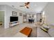 Open-concept living room with neutral tones, modern furniture, and a view into the dining area at 1036 Salamanca Pl, Davenport, FL 33837