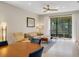 Bright living and dining area with modern furniture and sliding glass doors leading to an outdoor patio at 1036 Salamanca Pl, Davenport, FL 33837