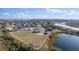 Community park equipped with playing fields and recreational spaces, nestled between houses and a serene lake at 1067 Ronlin St, Haines City, FL 33844