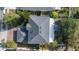 Birds eye view of the house featuring a gray roof, skylights, and mature landscaping on a sunny day at 1067 Ronlin St, Haines City, FL 33844