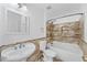 Bathroom showcasing a tub-shower combo with tiled walls and a unique pedestal sink at 1067 Ronlin St, Haines City, FL 33844