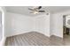 Bright bedroom with hardwood flooring, a ceiling fan, and an en-suite bathroom at 1067 Ronlin St, Haines City, FL 33844