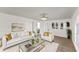 Bright living room with white sofas, a glass coffee table and views into the kitchen at 1067 Ronlin St, Haines City, FL 33844