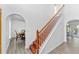 Bright entryway with hardwood stairs and white banister, showcasing architectural details and abundant natural light at 1067 Ronlin St, Haines City, FL 33844