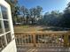 Spacious backyard view from the wooden deck overlooking a lush, tree-lined property at 11776 Nw 18Th Pl, Ocala, FL 34482