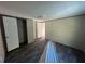 Bedroom with a closet, durable wood-look floors, and white walls at 11776 Nw 18Th Pl, Ocala, FL 34482