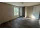 Bedroom with durable wood-look floors, closet, and a view to the outdoors through a window at 11776 Nw 18Th Pl, Ocala, FL 34482