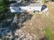 Aerial view of home with siding and wooden stairs in a spacious yard with trees at 11776 Nw 18Th Pl, Ocala, FL 34482