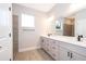 Bathroom featuring double sinks, tile accent wall and a large mirror at 12691 Sw 33Rd Ave, Ocala, FL 34473