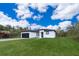 Charming single-story home with a well-manicured lawn and black garage door at 12691 Sw 33Rd Ave, Ocala, FL 34473