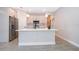 Bright kitchen island with modern fixtures, stainless refrigerator and stylish cabinets at 12691 Sw 33Rd Ave, Ocala, FL 34473