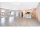 Bright, open-concept living room with tile floors and a view into the modern kitchen at 12691 Sw 33Rd Ave, Ocala, FL 34473