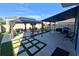 Outdoor space showcasing a covered patio with a seating area and lush landscaping at 1292 Cascades Ave, Davenport, FL 33837