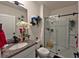 Bright bathroom featuring a granite countertop, a vessel sink, and a sliding glass shower door at 1292 Cascades Ave, Davenport, FL 33837