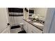 Modern bathroom featuring a double vanity, granite countertops, decorative shower curtain, and gray tile flooring at 1292 Cascades Ave, Davenport, FL 33837