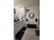 A neutral-toned bathroom features a double vanity, decorative round mirrors, a black bench, and a glass shower at 1292 Cascades Ave, Davenport, FL 33837