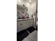 Bathroom featuring a double vanity with granite top, decorative mirrors, and a glass shower in neutral tones at 1292 Cascades Ave, Davenport, FL 33837