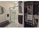 Modern bathroom featuring a glass-enclosed shower, neutral color palette, and well-organized closet space at 1292 Cascades Ave, Davenport, FL 33837