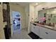 Spacious bathroom with double vanity sinks, granite countertops and adjoining open bedroom at 1292 Cascades Ave, Davenport, FL 33837