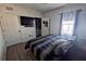 Bedroom featuring dark wood floors, and ensuite closet and laundry room at 1292 Cascades Ave, Davenport, FL 33837