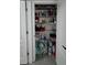 Linen closet with shelving, stocked with household supplies for easy access and organization at 1292 Cascades Ave, Davenport, FL 33837