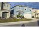 Charming two-story home boasts blue exterior, well-manicured lawn, and a two-car garage at 1292 Cascades Ave, Davenport, FL 33837