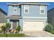 Charming two-story home featuring a well-manicured front yard and a two car garage at 1292 Cascades Ave, Davenport, FL 33837