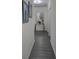 Hallway features wood-look flooring and a decorative console table with a large, ornate mirror at 1292 Cascades Ave, Davenport, FL 33837