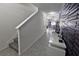 Hallway with modern textured wall panel and white console table with decor at 1292 Cascades Ave, Davenport, FL 33837