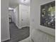 Hallway with hardwood flooring, leading to various rooms and showcasing neutral wall tones at 1292 Cascades Ave, Davenport, FL 33837