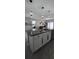 Kitchen island featuring gray countertops, modern fixtures, and view to the living room at 1292 Cascades Ave, Davenport, FL 33837