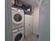 Convenient laundry room featuring stacked washer and dryer and storage cabinets at 1292 Cascades Ave, Davenport, FL 33837