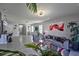 Bright, open living room featuring contemporary furnishings and decor, with an open transition to the kitchen area at 1292 Cascades Ave, Davenport, FL 33837