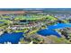 Panoramic aerial view of a residential area, showcasing golf course fairways and a network of lakes at 142 Magellan Ct, Davenport, FL 33837